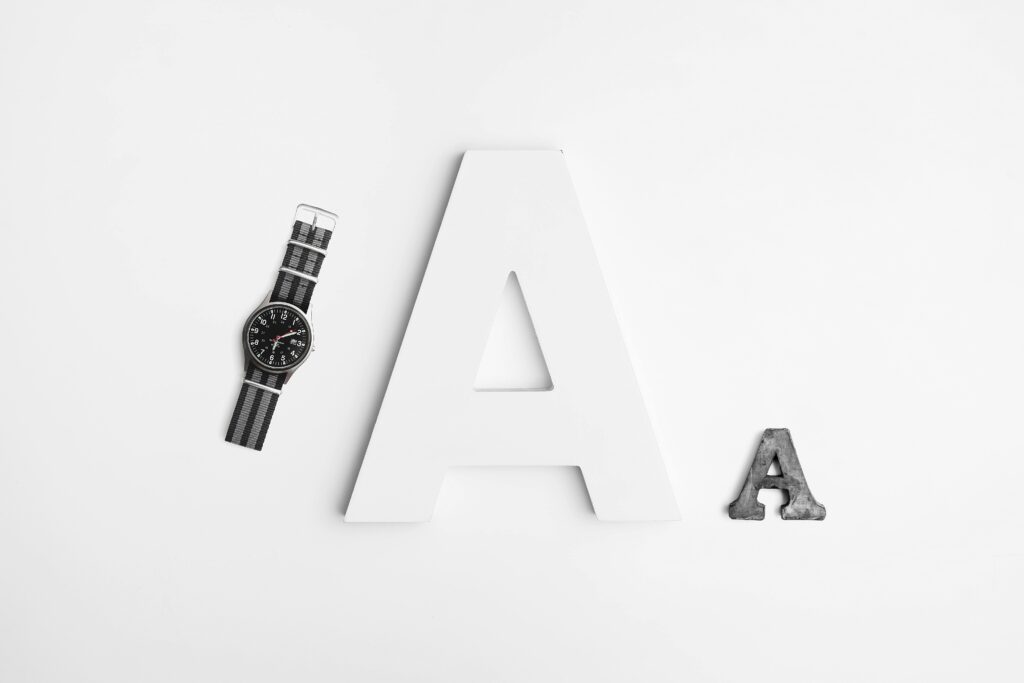 pexels-photo-861449-861449 Minimalist layout featuring typography with a sleek watch and bold letter A design.