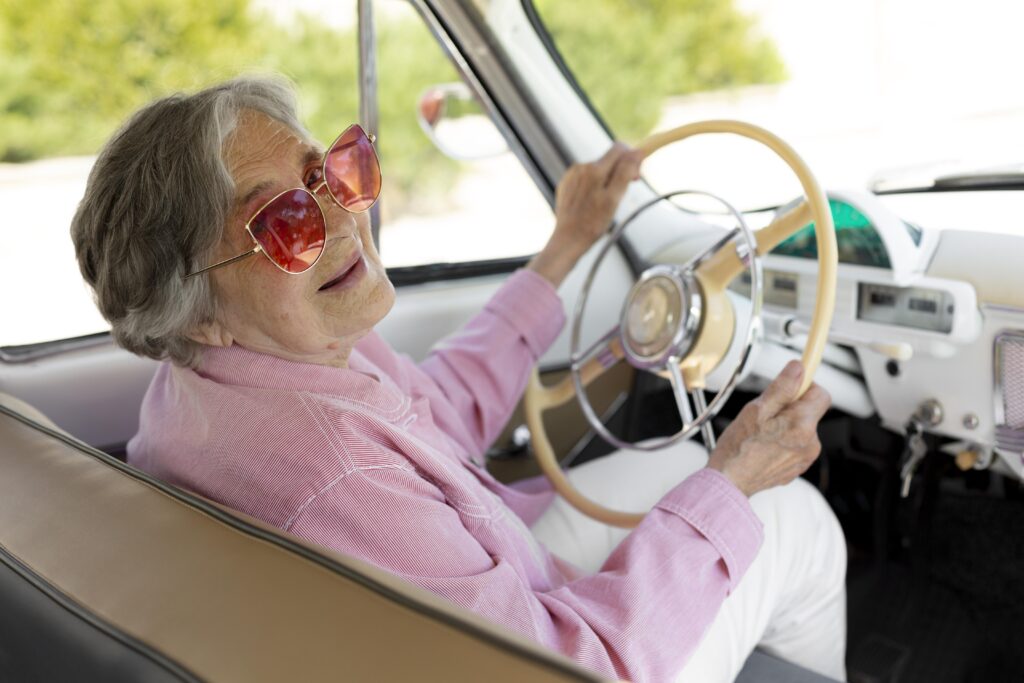 happy senior woman traveling alone by car (1)